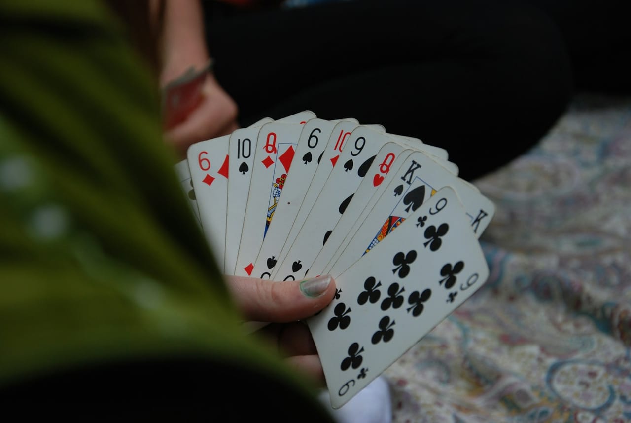 A hand of playing cards held in a fan