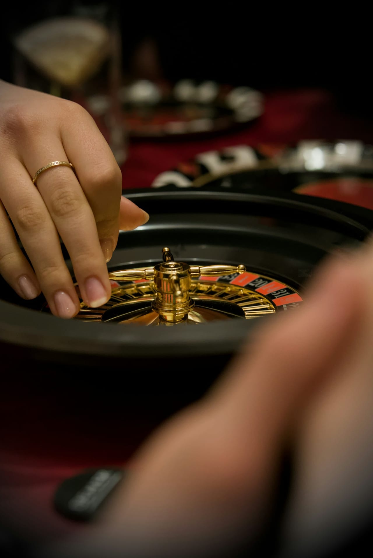 Hands placing chips on a roulette table